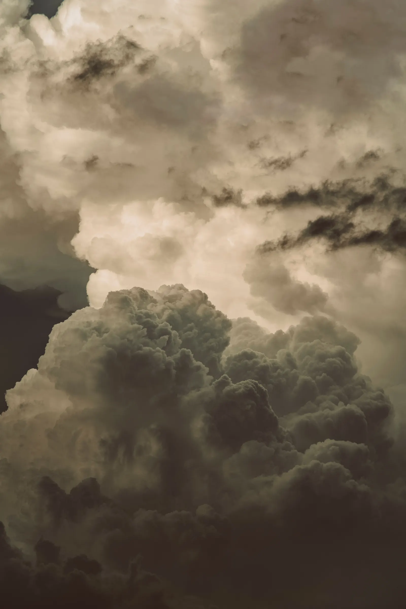 Towering storm clouds building in a sepia sky